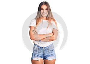 Beautiful caucasian woman wearing casual white tshirt happy face smiling with crossed arms looking at the camera