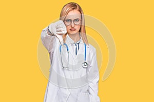 Beautiful caucasian woman wearing doctor uniform and stethoscope looking unhappy and angry showing rejection and negative with