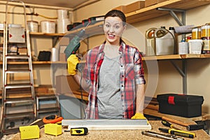 Beautiful caucasian young woman working in carpentry workshop at table place photo