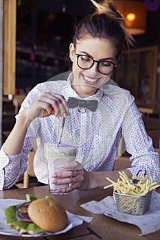 Beautiful caucasian young woman eating lunch fast food fried pot