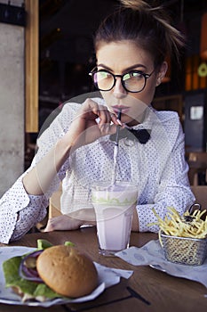 Beautiful caucasian young woman eating lunch fast food fried pot