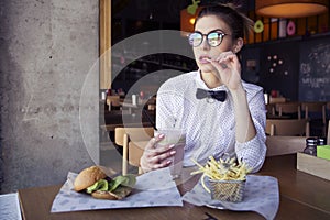 Beautiful caucasian young woman eating lunch fast food fried pot