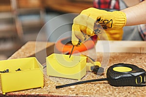 Beautiful caucasian young woman working in carpentry workshop at table place