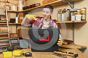 Beautiful caucasian young woman working in carpentry workshop at table place