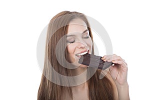 Beautiful caucasian ypung woman eating a chocolate bar.