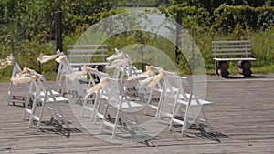 Beautiful chairs with ribbons at the wedding reception.