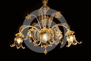 Beautiful chandelier (Murano Italy) isolated on black background.