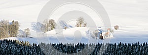 Beautiful chapel in lovely rural countryside on snowy winter sunrise seen from above. Weitnau, Allgau, Bavaria, Germany.