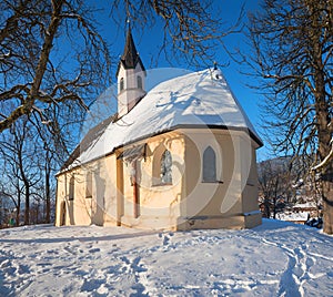 Beautiful chapel St Georg, at Weinberg hill schliersee, winter landscape bavaria