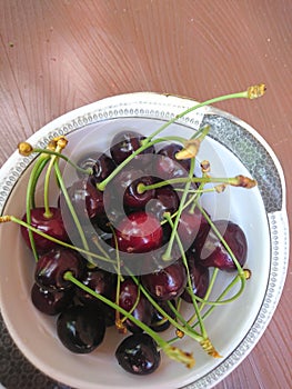 Beautiful charry in plate on the table. Ready for eating.