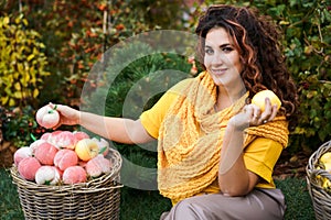 Beautiful cheerful curly red-haired woman sitting with large baskets