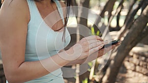 Beautiful Cheerful Girl With a Tablet PC Sitting In a Park on a Bench on a Sunny Day, On-line Shopping Concept