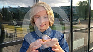 Beautiful cheerful school girl playing with a gold fidget spinner. A popular trendy toy.