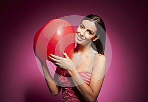 Beautiful cheerful woman with valentines day balloon