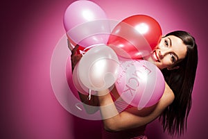 Beautiful cheerful woman with valentines day balloon