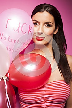 Beautiful cheerful woman with valentines day balloon