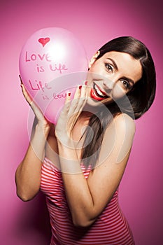 Beautiful cheerful woman with valentines day balloon