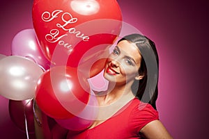 Beautiful cheerful woman with valentines day balloon