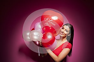 Beautiful cheerful woman with valentines day balloon