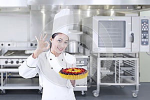 Chef holds delicious cake - horizontal