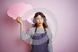 Beautiful chef woman wearing apron holding cloud speech bubble over isolated pink background with a confident expression on smart