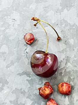 Beautiful cherry on the table and on the saucer. Cherries and cherry stones, pits on a plate