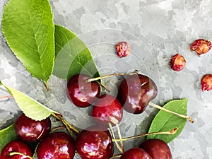 Beautiful cherry on the table and on the saucer. Cherries and cherry stones, pits on a plate.