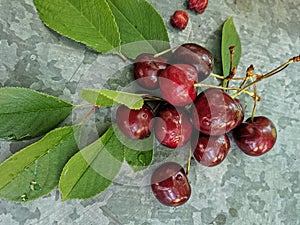 Beautiful cherry on the table and on the saucer. Cherries and cherry stones, pits on a plate