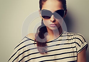 Beautiful chic lady posing in fashion sun glasses. Closeup color