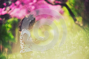 Beautiful child with dandelion flower in spring park. Happy kid