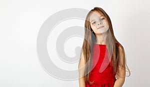 Beautiful child girl in an elegant red dress on a white background. Childhood. Children`s fashion. Children holidays. Little