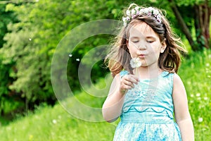 Beautiful child girl in park. Happy kid having fun outdoo