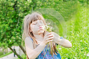 Beautiful child girl in park. Happy kid having fun outdoo