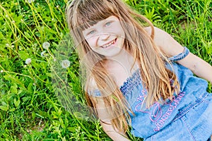 Beautiful child girl in park. Happy kid having fun outdoo