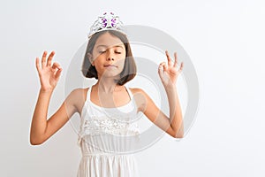 Beautiful child girl wearing princess crown standing over isolated white background relax and smiling with eyes closed doing
