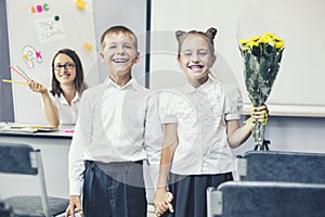 Beautiful children school children with flowers for the teachers