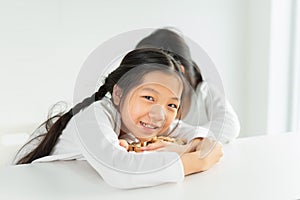 beautiful children smile, happy, look at camera, cherish alphabet or letter toy block on table. asian children study and learn