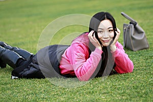 Beautiful china girl Lie on the grass