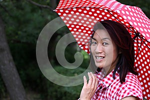 Beautiful Chinese girl smiling with an umbrella