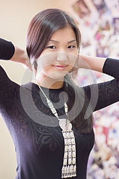 Beautiful Chinese girl wears a national Yakut ornaments.