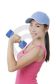 Asian teenager working out using dumbbell weights isolated on white background