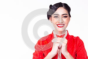 Beautiful Chinese woman greeting someone in Chinese New year day. Pretty asian woman is blessing, wishing people to get prosperity