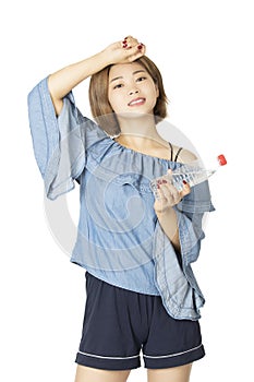 Beautiful Chinese woman holding water bottle isolated on white background