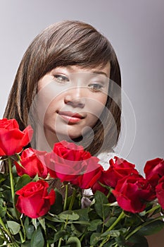 Beautiful chinese woman and red roses