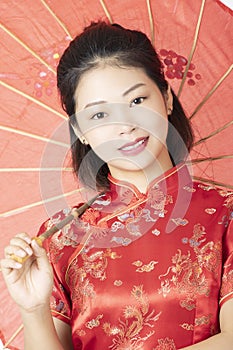 Beautiful Chinese woman wearing a Chipao isolated on white background