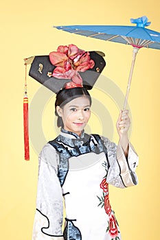 Beautiful Chinese Woman wearing traditional outfit against yellow background