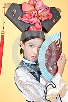 Beautiful Chinese Woman wearing traditional outfit against yellow background