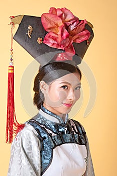 Beautiful Chinese Woman wearing traditional outfit against yellow background
