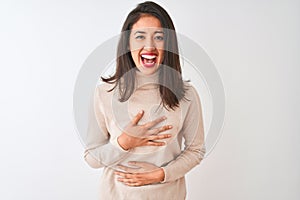 Beautiful chinese woman wearing turtleneck sweater standing over isolated white background smiling and laughing hard out loud