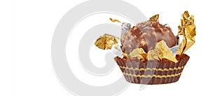 Beautiful chocolate candy ball shape in an open gold wrapper isolated on white with shadows and copy space for your text
